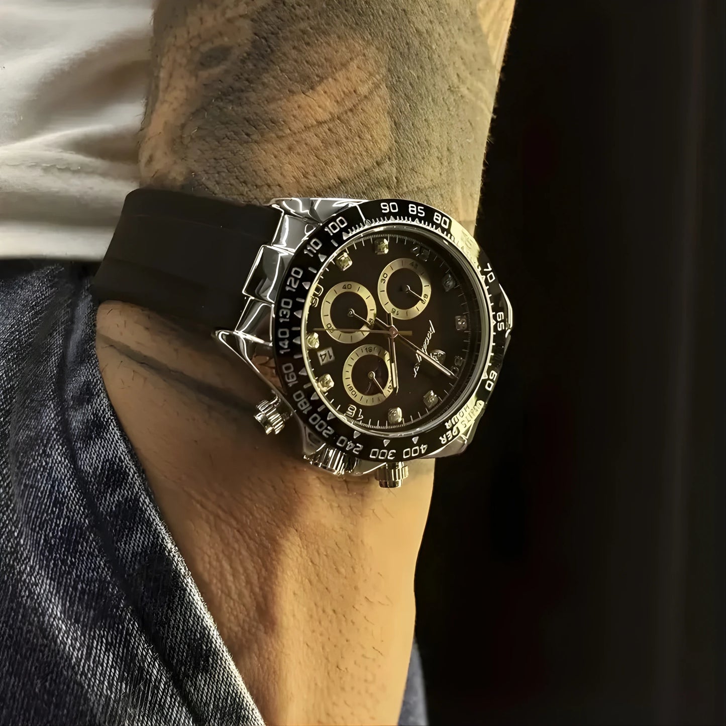 Luxury watch on a person's wrist with a dark background