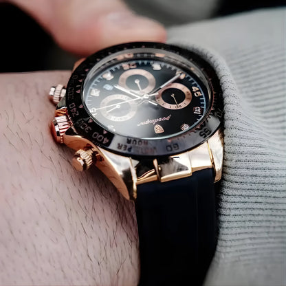 Luxury watch with black face and rose gold case on a wrist