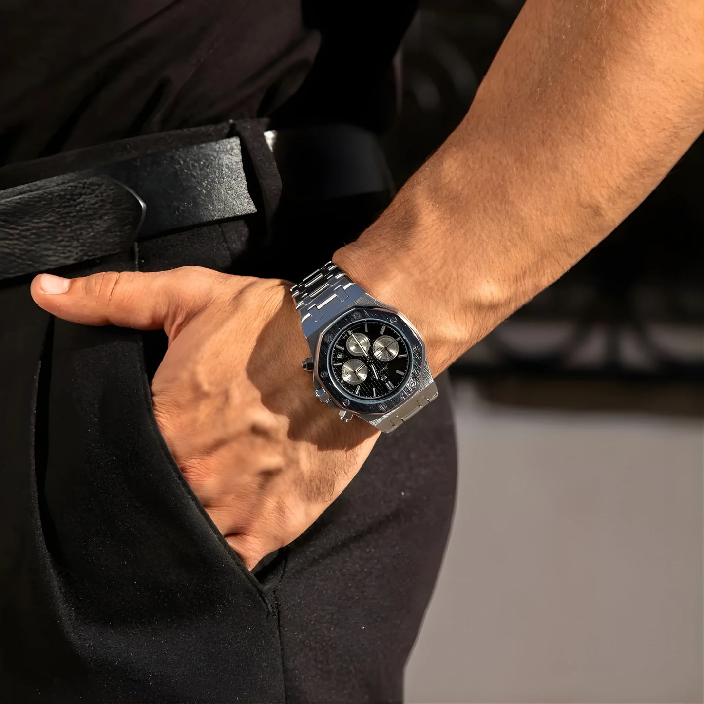 Person wearing a black watch with a blurred background