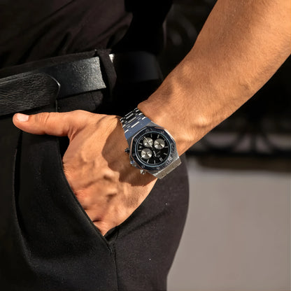 Person wearing a black watch with a blurred background